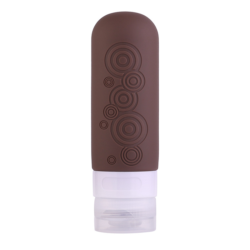 Refillable silicone travel bottle with embossed geometric pattern and leak-proof cap for toiletries and skincare liquids.