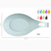 Heat-resistant silicone spoon rest and utensil holder for kitchen countertop with a large drip pad design for cooking spatulas.