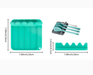Multi-slot silicone utensil rest with drip pad for holding spatulas, ladles, and tongs on the kitchen countertop while cooking.