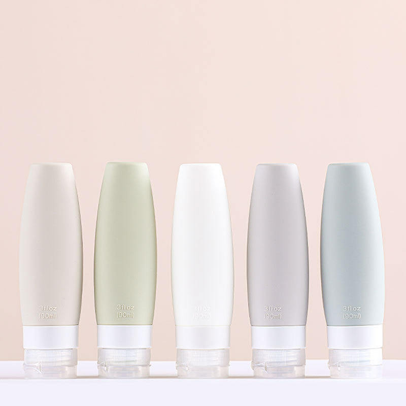Designer silicone travel bottles with leaf-vein textured grip in four sizes for leak-proof skincare and cosmetic dispensing.