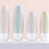 Designer silicone travel bottles with leaf-vein textured grip in four sizes for leak-proof skincare and cosmetic dispensing.