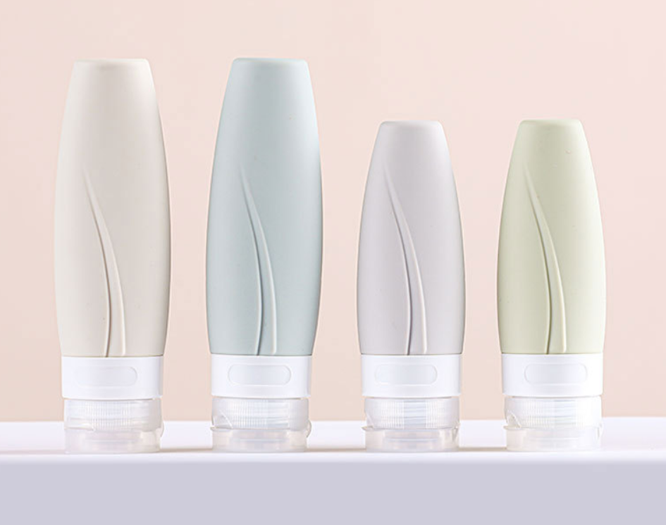 Designer silicone travel bottles with leaf-vein textured grip in four sizes for leak-proof skincare and cosmetic dispensing.