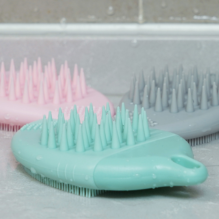 Leaf-shaped FDA food-grade silicone cleaning brush with soft bristles for gentle facial exfoliation and body massage.