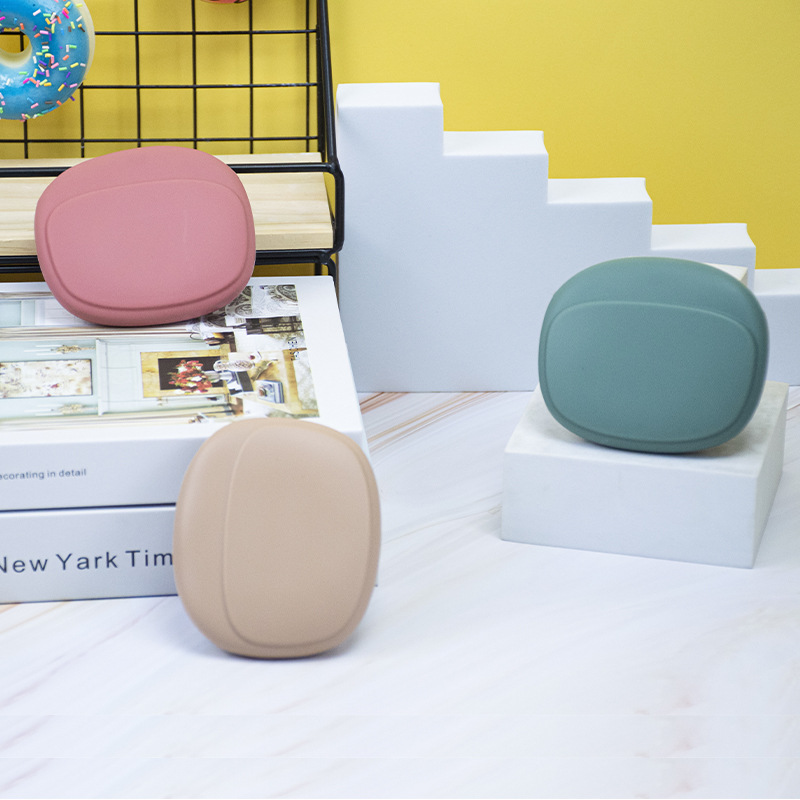 Minimalist matte silicone earphone cases in dusty rose, sage green, and beige, displayed on a clean aesthetic desk setup for tech organization.